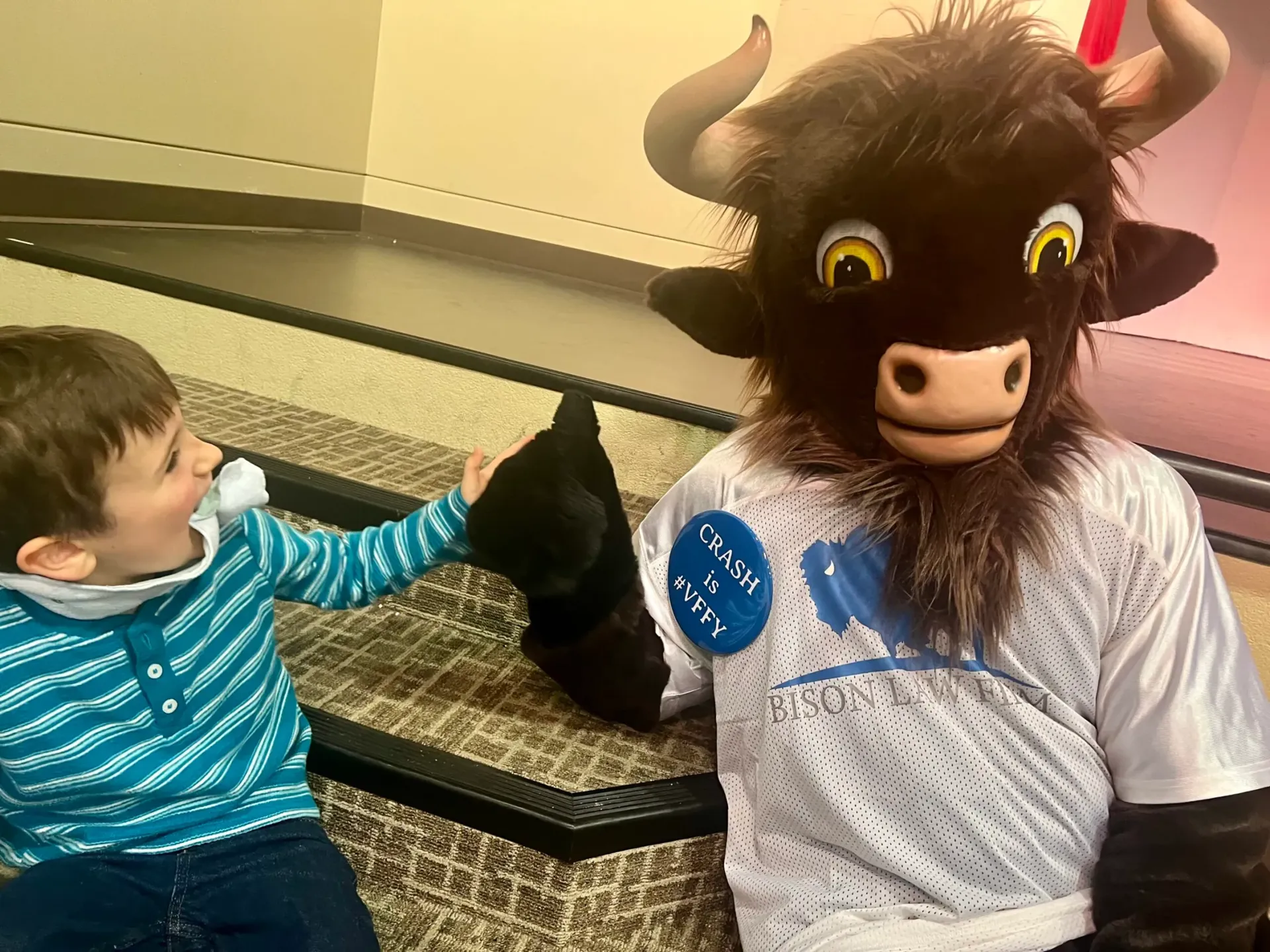 Crash the Bison, Bison Law Firm's mascot, visits the students at Special Care Inc.