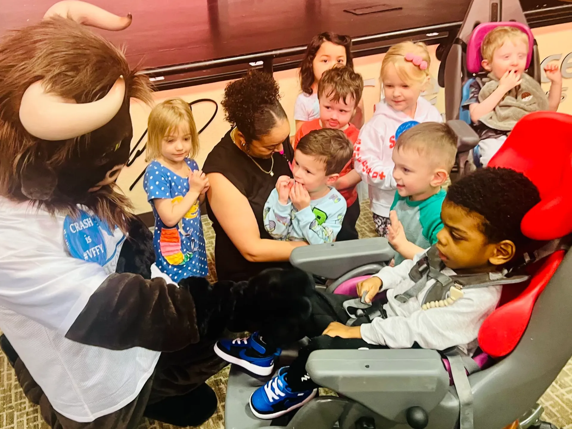 Crash the Bison, Bison Law Firm's mascot, visits the students at Special Care Inc.