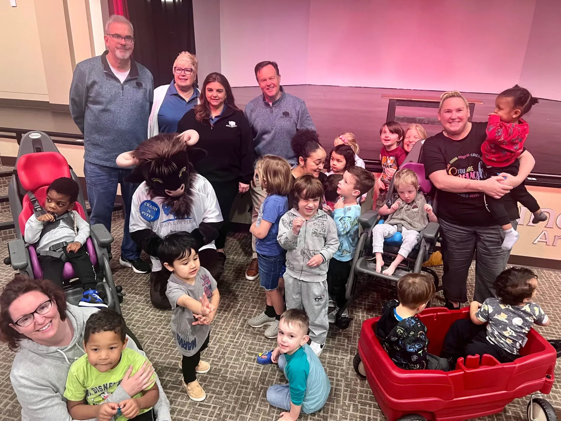 Crash the Bison, Bison Law Firm's mascot, visits the students at Special Care Inc.